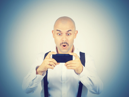 Man reading sms on your smartphone. Emotions.の写真素材