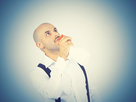 bald male cleaning worker spraying liquid detergent in front of him, の写真素材