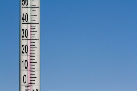 Climate Change Thermometer Gives Indicates Heat in The Atmosphere.  Heat Of Summer on a Natural Sky Background.の写真素材
