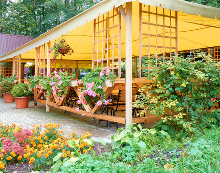Old Vintage Street Cafe under Canopy. Many Colorful Flowers in hanging pots.の写真素材