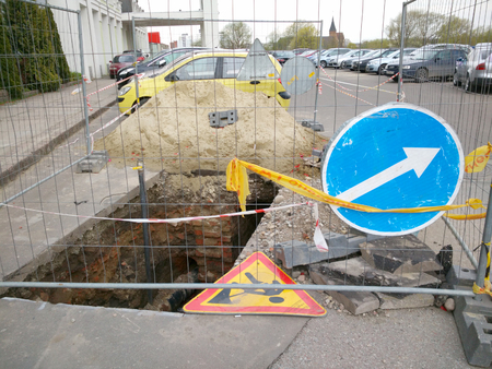 Damaged asphalt road. Repair of engineering road highways. Detour sign on road especially dangerous pits. Dangerous  Emergency  Wounds Bad.の写真素材