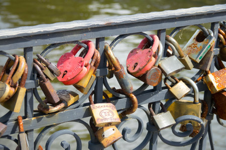 Love padlocks on the bridge. Wedding locks on a metal fencing. Love locks that couples hand on bridges to symbolize their true love. Kaliningrad - July 2017 Russian.のeditorial素材