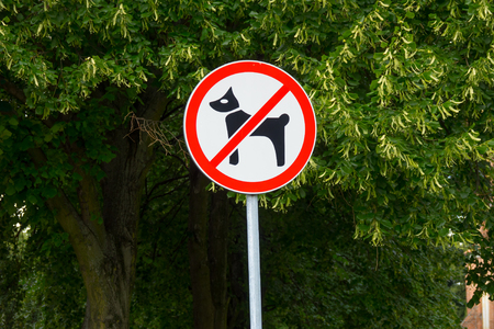 Dogs not permitted in area sign. Plate on post in city park -  no dogs allowed.の写真素材