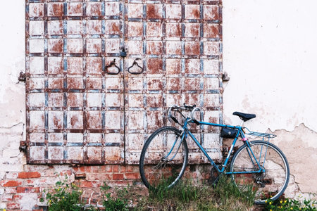 Old rusty door and bikeの写真素材