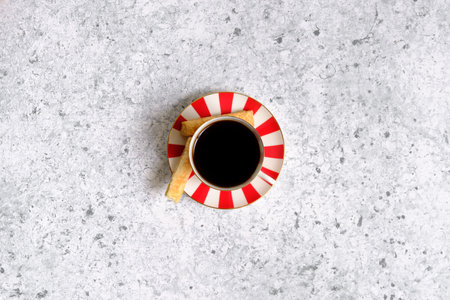 Coffee in a cup, cookies and gray backgroundの写真素材