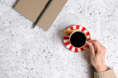 Coffee in a cup, cookies and notepadの写真素材