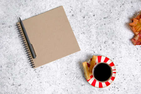 Coffee in a cup, cookies and notepadの写真素材