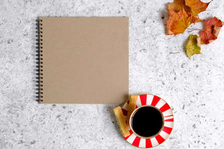 Coffee in a cup, cookies and notepadの写真素材