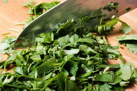 Chopping parsley on a cutting boardの写真素材