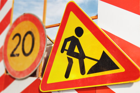 Forbidding speed limit road sign, warning road sign of repair work.