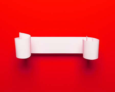 Realistic detailed curved white paper banner, ribbon isolated on red backgroundの写真素材