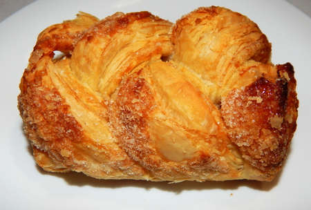 Homemade puffs with sugar on a white plate close-up.の写真素材