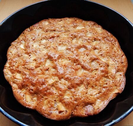 Apple pie in a baking dish is on the tableの写真素材