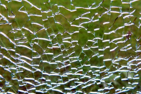 Broken glass on a background of green grassの写真素材