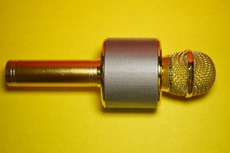 Karaoke microphone on a yellow background close upの写真素材