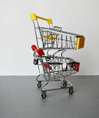 Two empty shopping carts from the supermarket. They are located on top of each other.の写真素材