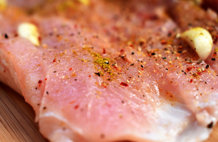 Raw pork fillet with spices close-upの写真素材