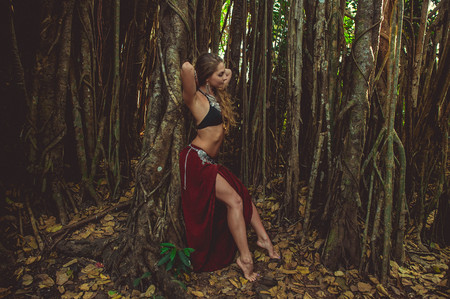 Girl in ethnic dress on a background of the sacred banyanの写真素材