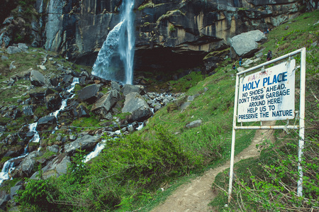 In the front white sign on background jogini waterfallの写真素材