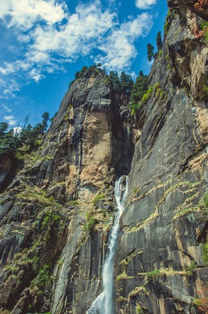 In the front big Jogini waterfall in Vashisht on background blue sky with cloudsの写真素材