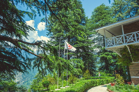 In the front Nicholas Roerich house and flag of peace on background Himalayan mountans and blue sky with cloudsの写真素材