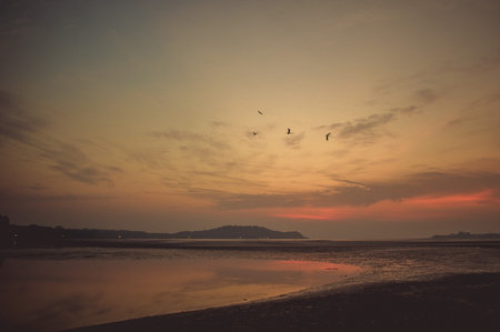 Sky at sunset time on the background rock in the sea.