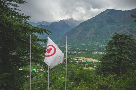 View from the house of Nicholas Roerich: the flag of the World against the backdrop of the Kullu valley and the Himalayan mountains.の写真素材