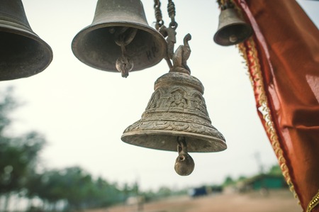 Bell with ornament on the background of trees.の写真素材