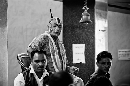Rishikesh. India. April 12, 2017: A man in a ritual coloring sits on a chair near the entrance to the temple and rings the bell.のeditorial素材