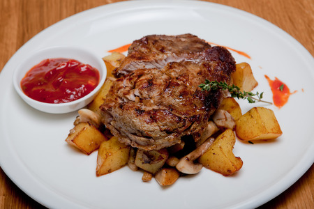 Pork steak with vegetable stew and sauce sweet chiliPork steak with vegetable stew aの写真素材