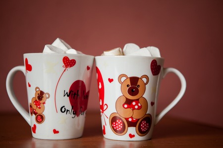 Hot chocolate with white marshmallows in hearts and teddy bears on Valentines Dayの写真素材