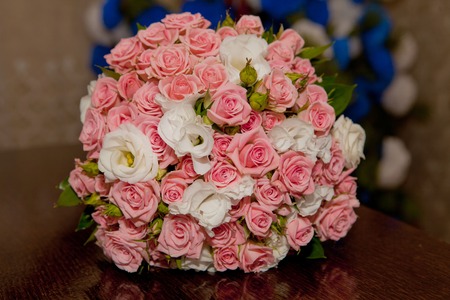 Beautiful wedding bouquet of pink roses on the tableの写真素材