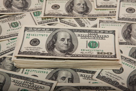 stack of dollars against the backdrop of money.の写真素材