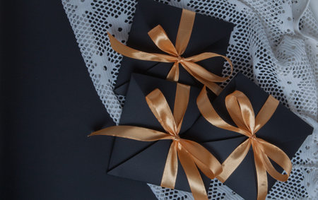 gift black opening, wrapped with a golden ribbon, top view