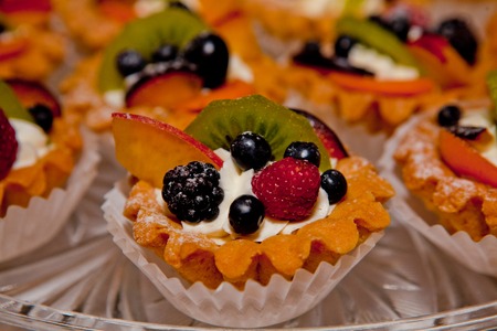 Cake with cream and fruit on the background of cakesの写真素材
