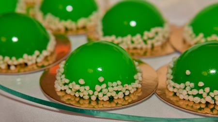 Trendy musk cake decorated with green mirror glaze. Concept of St. Valentine.の写真素材