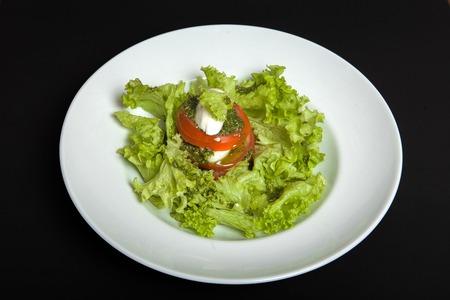 Caprese salad on the black background. Healthy Vegetarian Vegetarian Meal.の写真素材