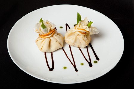 Pancakes with meat on a black background, a restaurant menu, a beautiful presentation.の写真素材