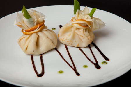 Pancakes with meat on a black background, a restaurant menu, a beautiful presentation.の写真素材