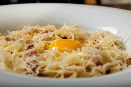 Italian cuisine, egg pouch, spaghetti, carbonate paste. Spaghetti Carbonara on the frontの写真素材