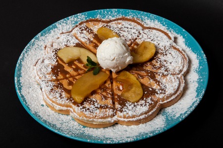 Chopped caramelized apples for breakfast on a black background.の写真素材
