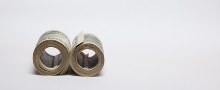 A roll of money, highlighted on a white background, a place for the text.の写真素材