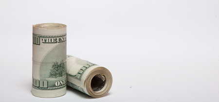 A roll of money, highlighted on a white background, a place for the textの写真素材