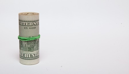 A roll of money, highlighted on a white background, a place for the text.の写真素材