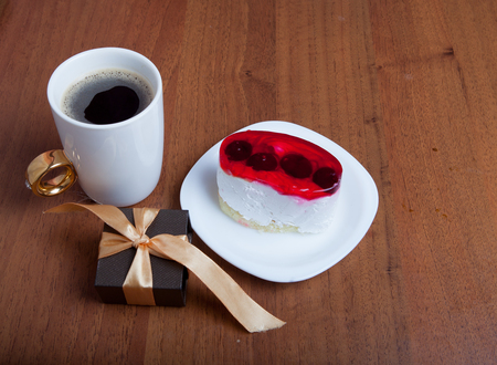 cake and coffee with a small gift on a wooden background. Valentine's Day.の写真素材