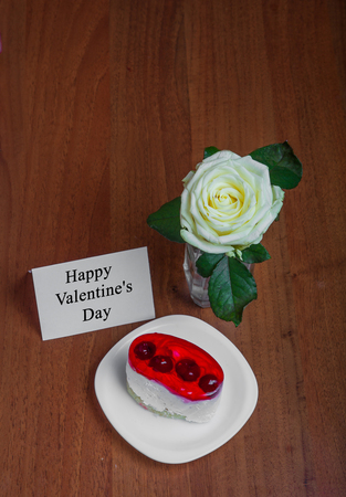 cake and roses with a place for text on a wooden background. Valentine's Dayの写真素材