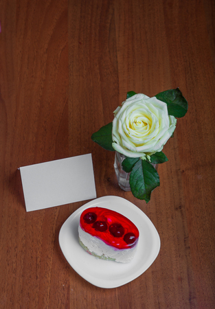 cake and roses with a place for text on a wooden background. Valentine's Dayの写真素材