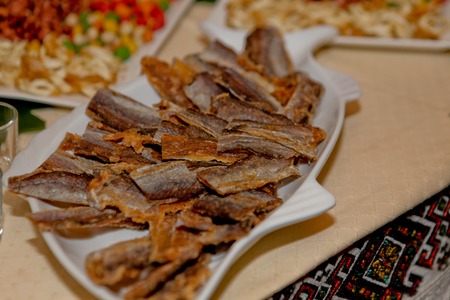 dried fish on a plate, snack on a wedding tableの写真素材
