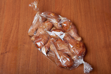 Chicken legs before baking in a baking sack.の写真素材
