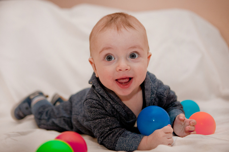 Happy child playing and having fun with colorful balls.の写真素材